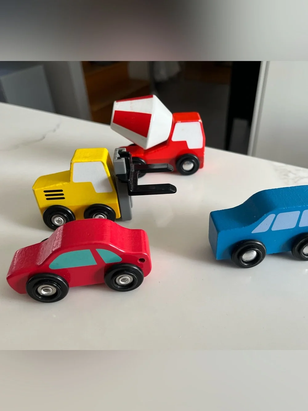 8 wooden cars and trucks.  Four are kidKraft.